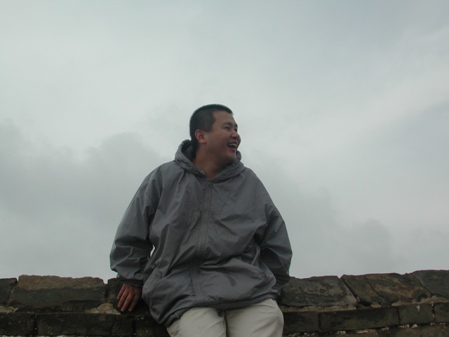 Woody sit on Beijing Simatai part of the Great Wall of China