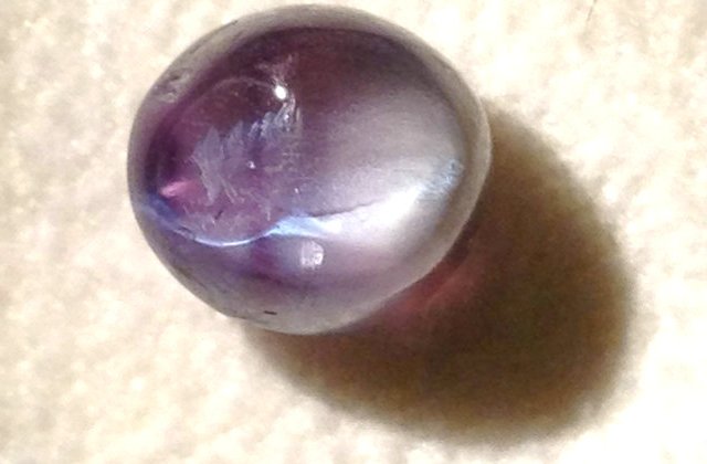 the back of alexandrite cat eye 3.89ct in yellow light